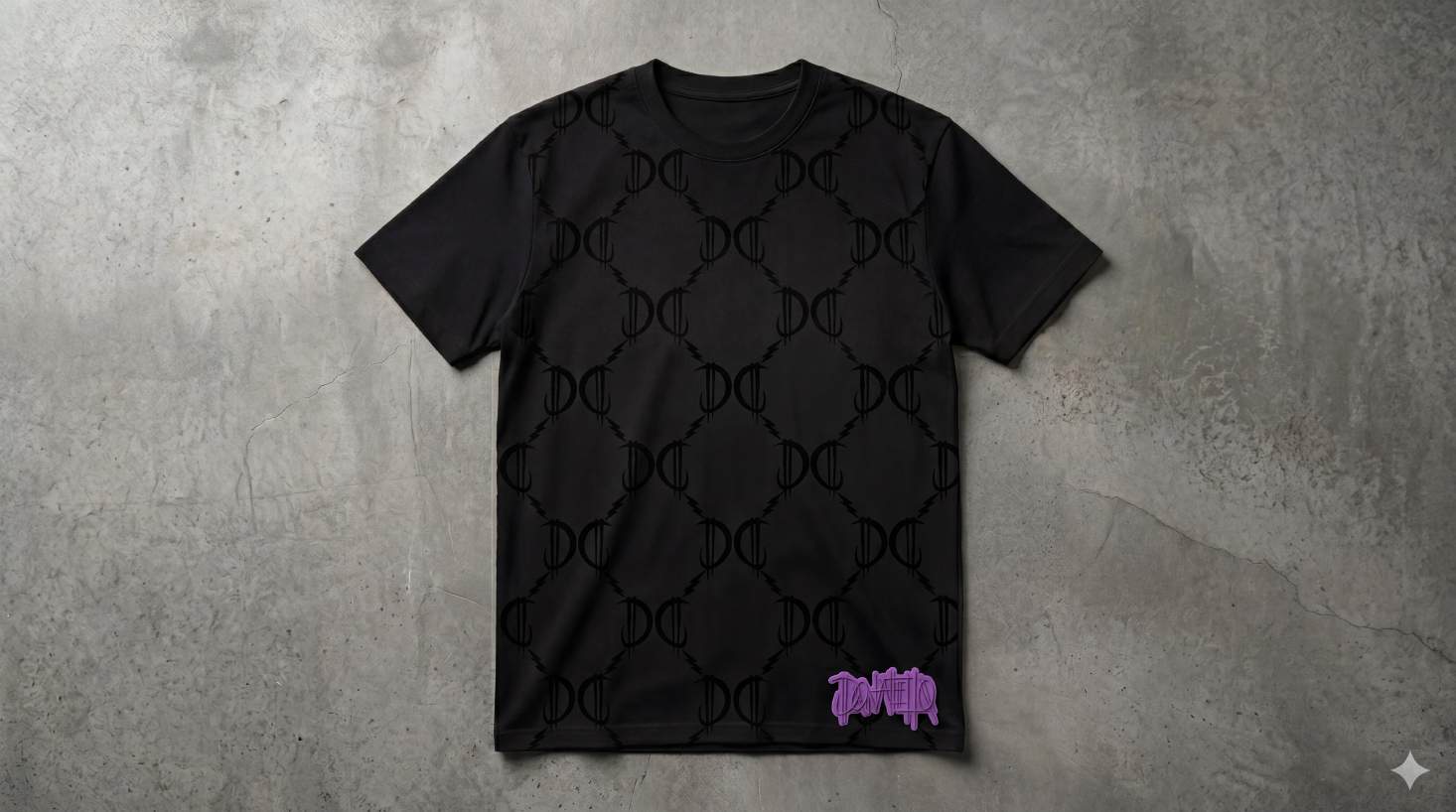 DC Monogram Tee — black heavyweight tee with tonal DC monogram pattern and violet Donatello tag at the hem